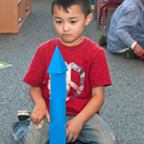 Little boy playing on shape blocks